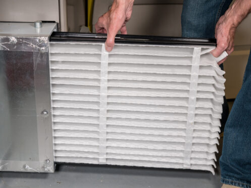 Changing the furnace filter to maintain airflow